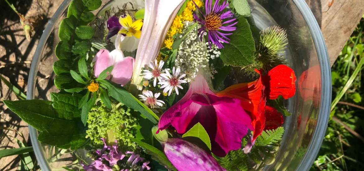 clear bowl filled with water & flowers